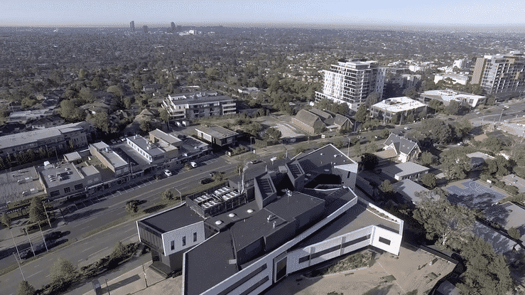 drone footage above doncaster hill showing buildings and shopping centre