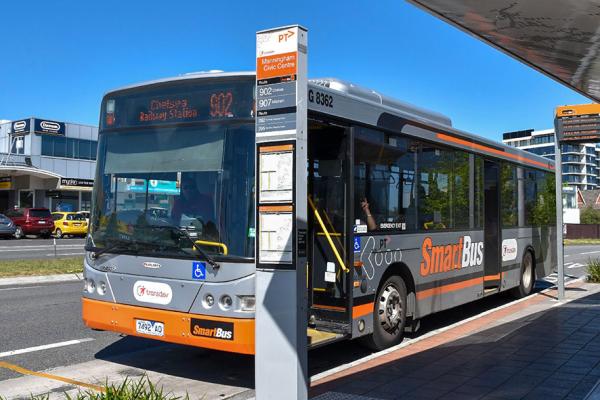 Photo of the front of a bus at a bus stop