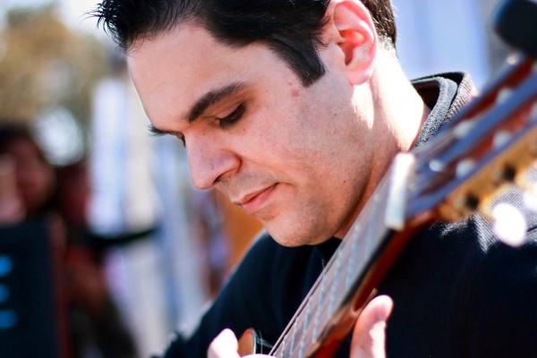 Man seated playing guitar