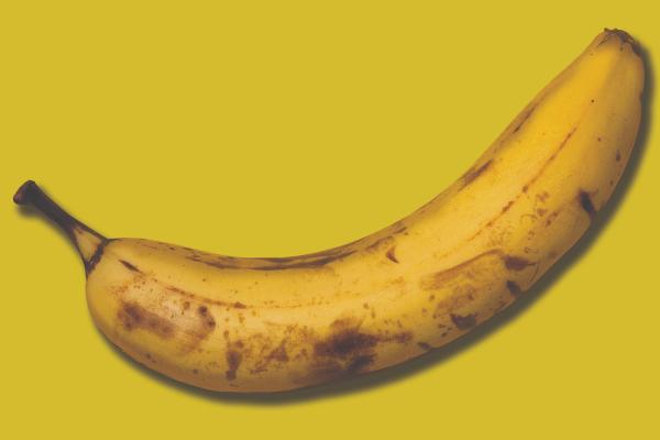 An old banana on a yellow background