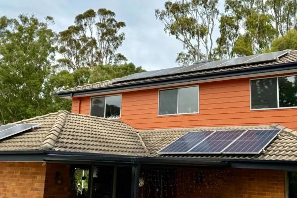 A two storey home with solar panels on the roof