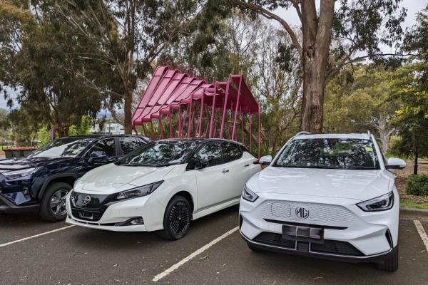 Three electric vehicles on display in a carpark