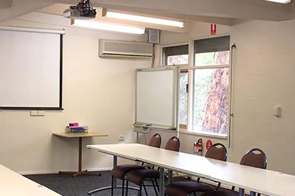 Inside the meeting room with projector and chairs