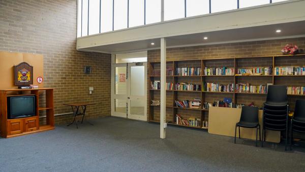 Photo of the lounge areas showing bookshelves and television