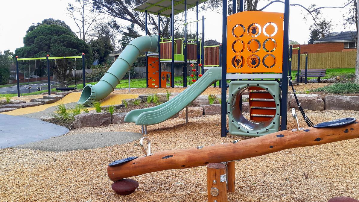 photo of the seesaw with two slides in the background