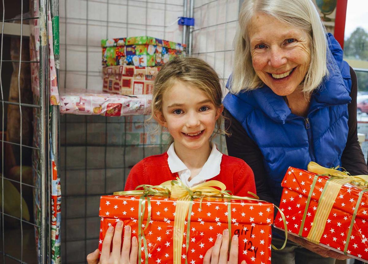 girl with grandmother holding christmas presents