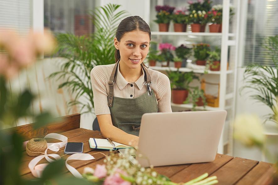 Small business florist on laptop