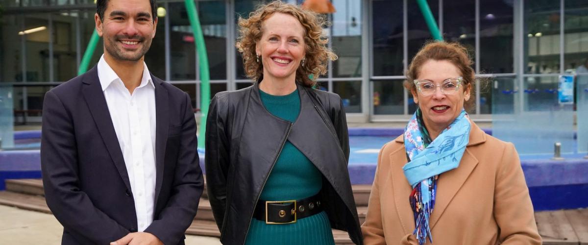 Federal Member for Menzies Gabriel Ng, Manningham Mayor Cr Deirdre Diamante, North-Eastern Metropolitan MP Sonja Terpstra standing in front of the children's outdoor pool.