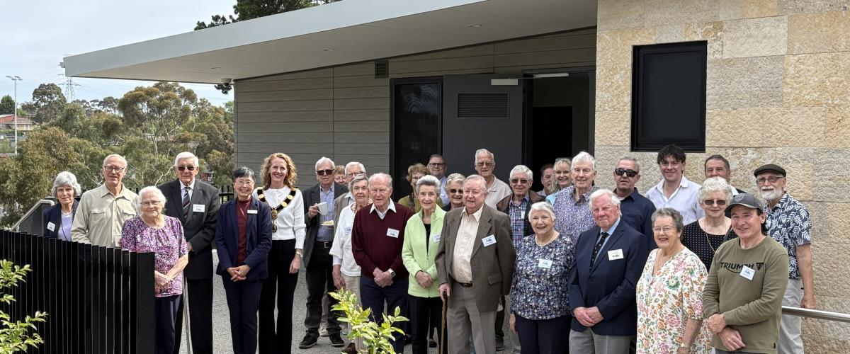 A group of people including the Mayor, Councillors and members of the Doncaster Templestowe Historical Society stand smiling at the camera out the front of the new Schramms Cottage Museum and Visitor Centre.
