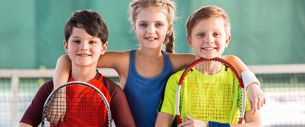 Group of kids with tennis rackets