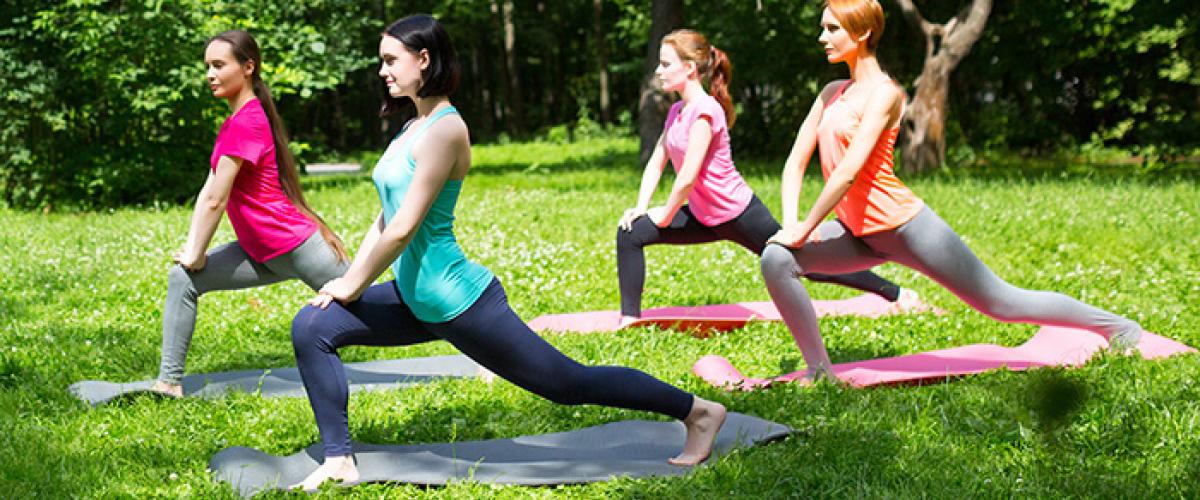 Women doing yoga in park