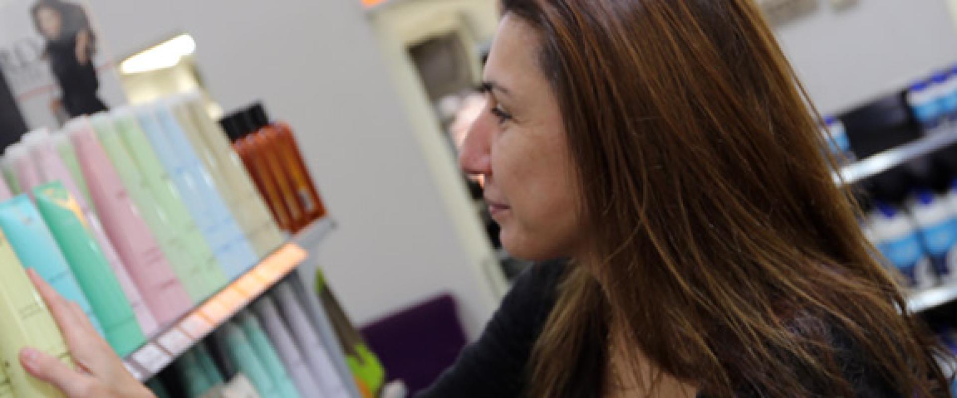 photograph of woman looking products on the shelf