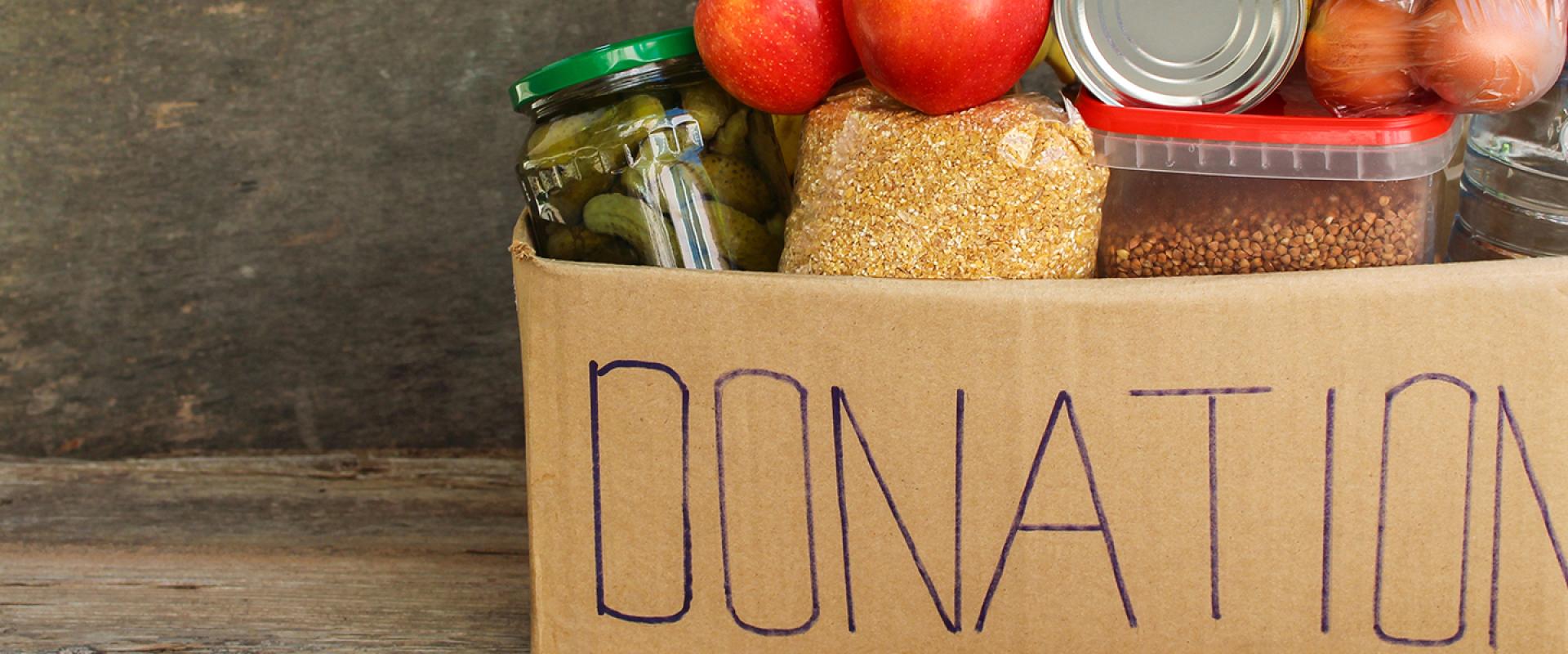Groceries in a box with donations written on the side