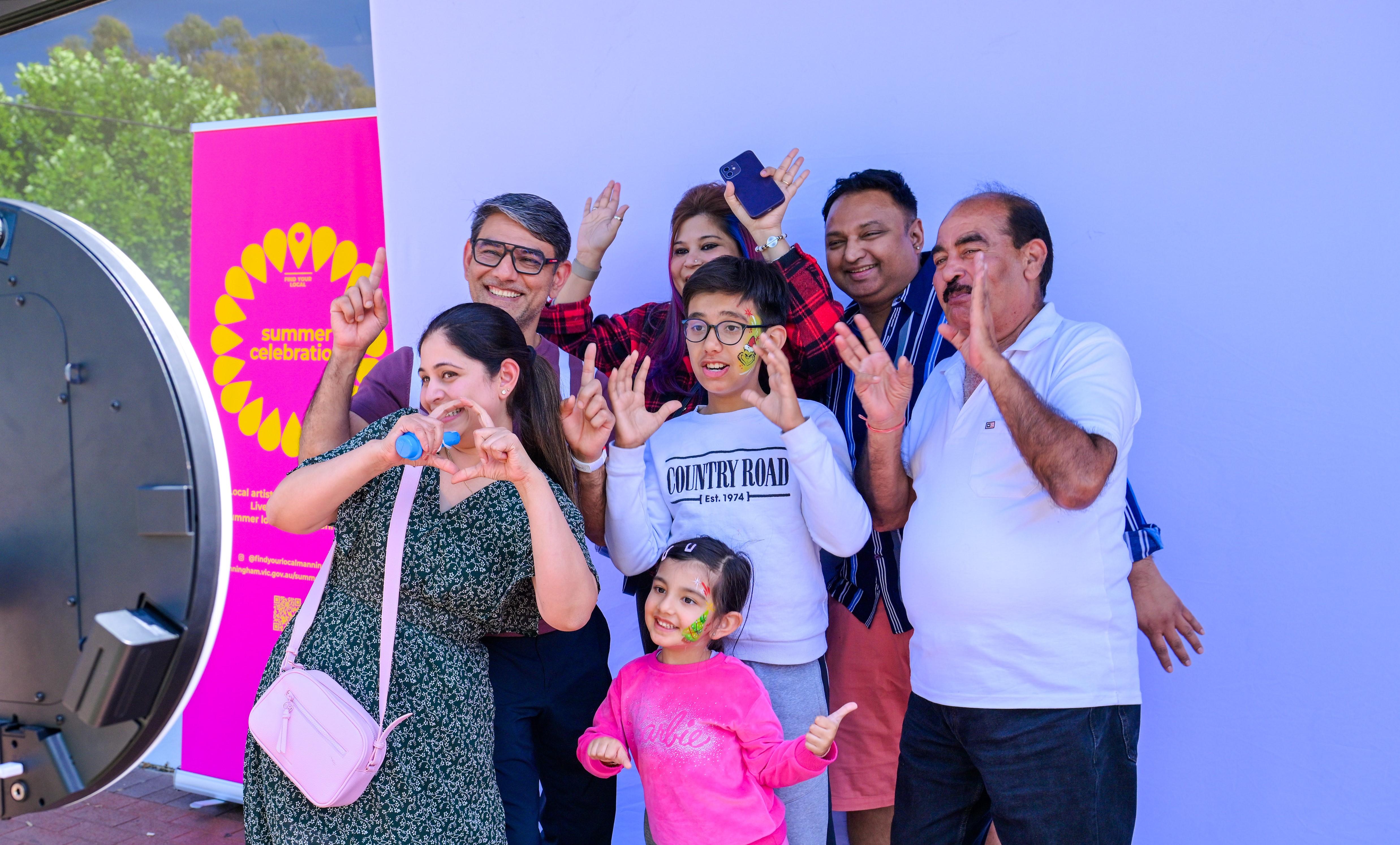 Family of 7 smiling and posing for a photo booth photo