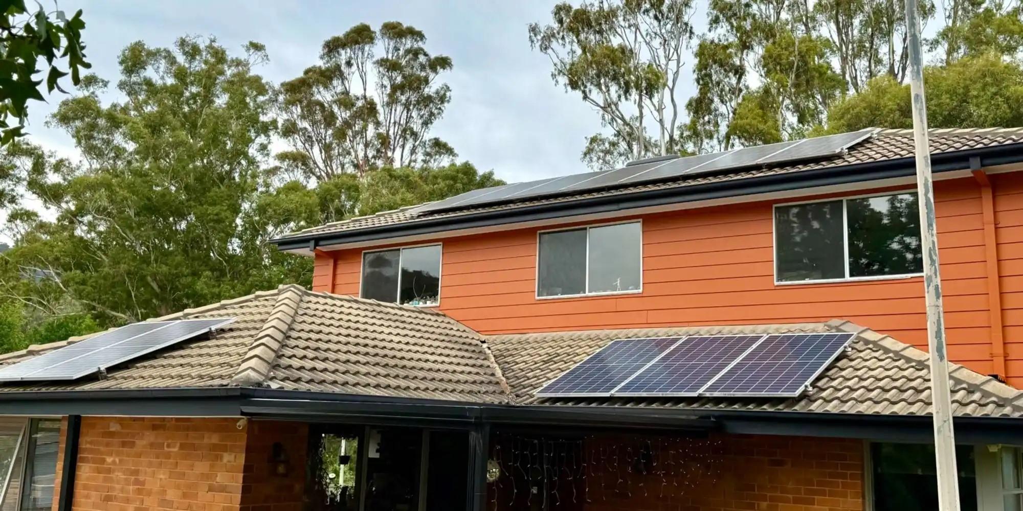 A two storey home with solar panels on the roof