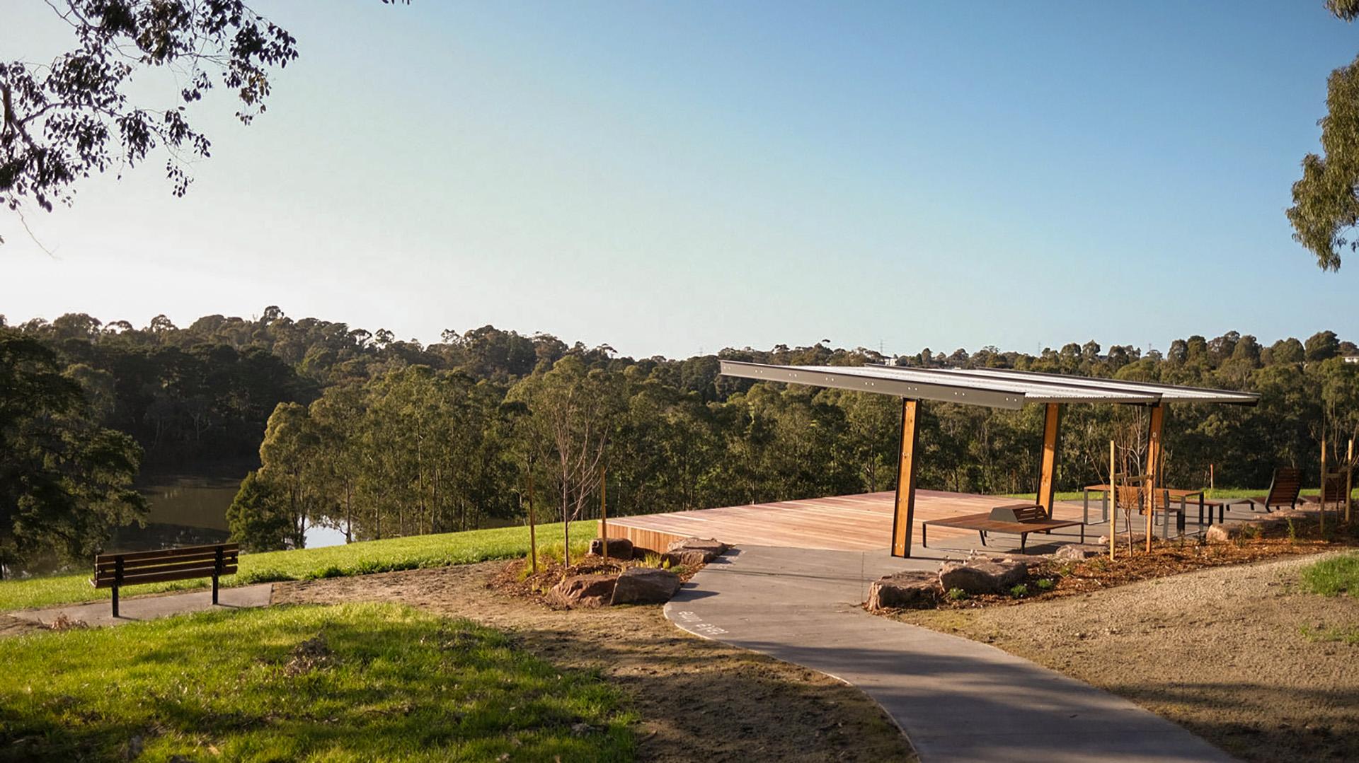 view of Ruffey Park lake with lookout deck and benches