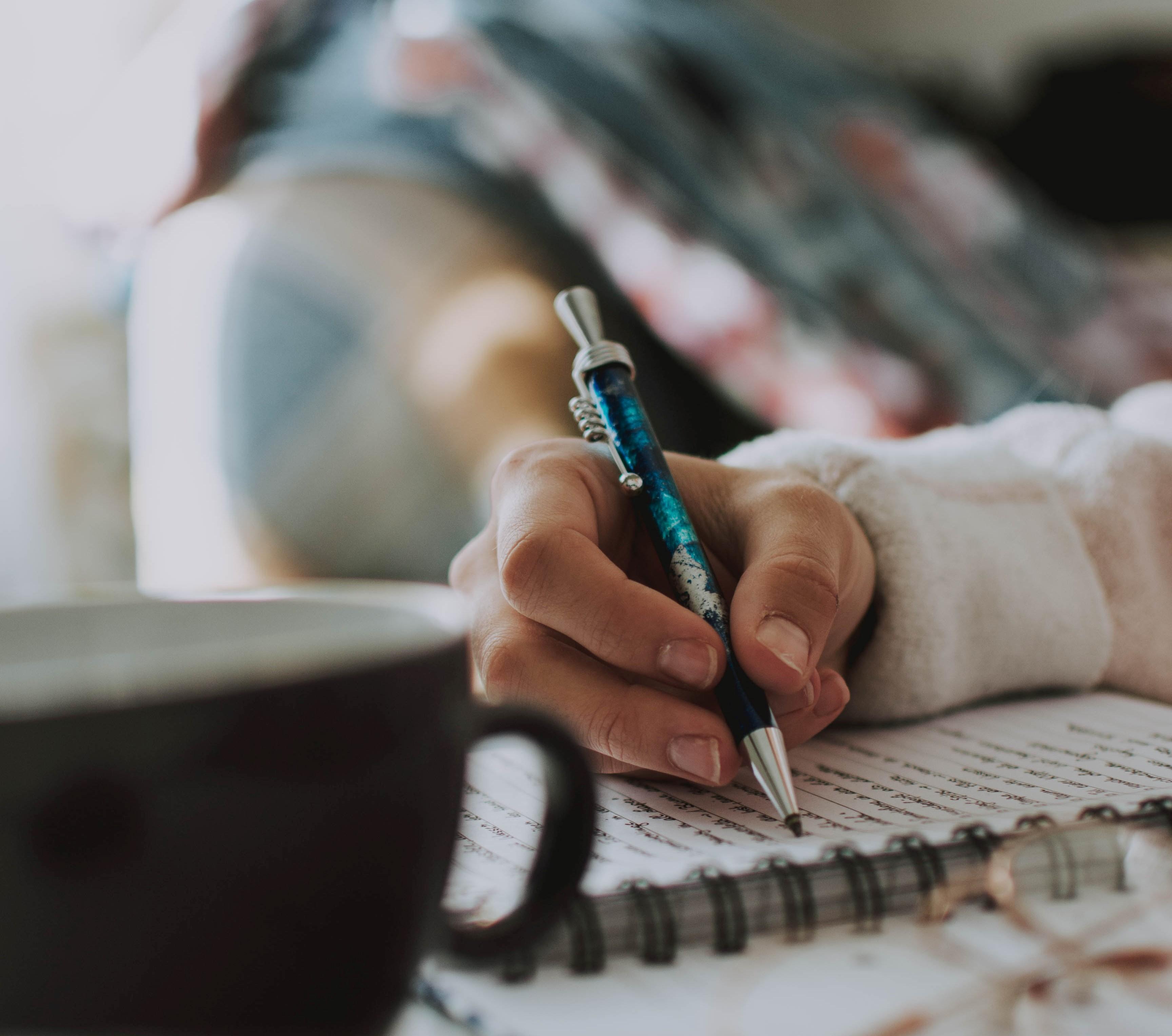 Writing with coffee cup