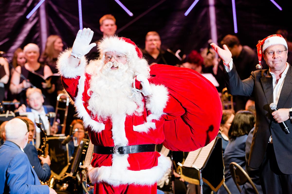 Santa waving at crowd on stage at Manningham Carols in 2017