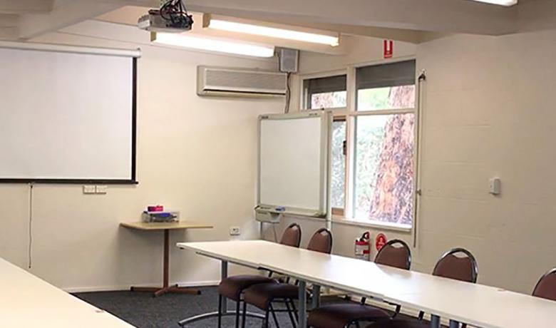 Inside the meeting room with projector and chairs