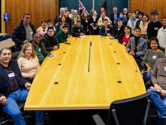 Photo of a group of people around the Council Chamber table