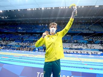 Bredon Smith at the Olympics holding medal