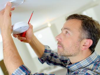 Man installing smoke alarm