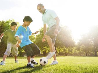 Family playing soccer