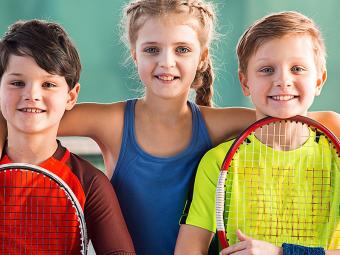 Group of kids with tennis rackets