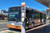 Photo of the front of a bus at a bus stop