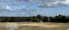 Oval with soccer goals at Timber Reserve with view of trees and city skyline